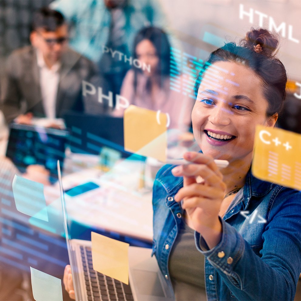 Smiling woman writing on glass with coding symbols overlay